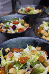 Greek salad served in black plates.