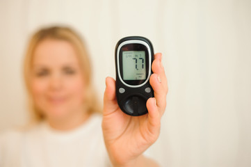 glucometer with result of measurement sugar level and tape measure, concept of diabetes