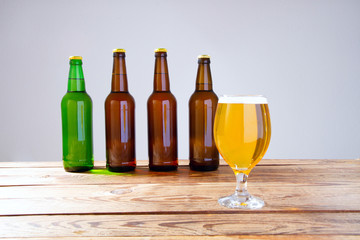 glass of beer on wooden table, top view. Beer bottles. Selective focus. Mock up. Copy space.Template. Blank.