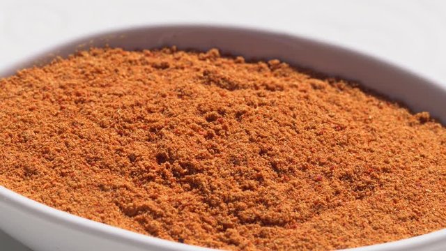 Dry spices paprika on a rotary table. 4K. Macroshooting.
