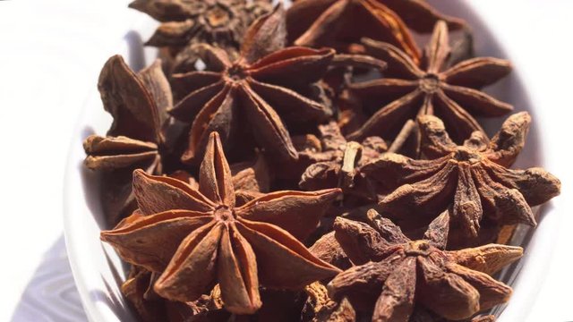 Dry spices anisetree on a rotary table. 4K. Macroshooting.
