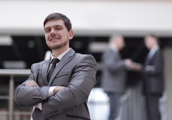 portrait of handsome businessman on blurred office background