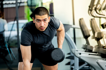 Fototapeta na wymiar Young sport man exercising in fitness gym