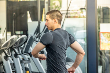 Young sport man exercising in fitness gym