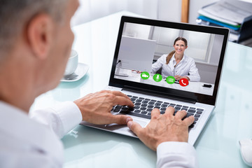 Businessman Videoconferencing With Doctor On Laptop