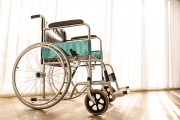 Wheelchair parking in the hospital room with sunlight in background, concept for the health care of the elderly or the disabled.