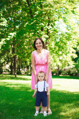 Fototapeta premium Happy young family spending time together outside in green nature.