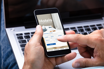 Man Booking Hotel Using Smartphone