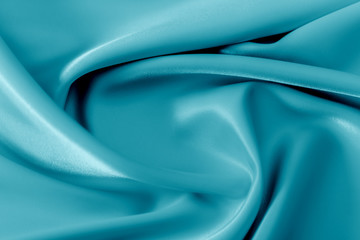 Smooth elegant shiny turquoise silk or satin luxury cloth texture can use as abstract holidays background. Luxurious Christmas background or New Year background design.