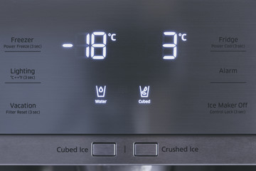 Steel modern touching panel of fridge water and ice dispenser.