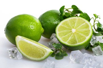 Fresh Leaves of Mint with Limes and Ice Cubes
