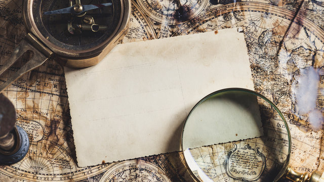 Old maps with marine equipment like compass, magnifier or hourglass and blank vintage card for your inscript. Columbus Day concept. - Powered by Adobe
