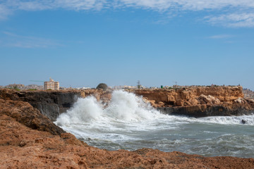 White ocean waves crashing to rocks