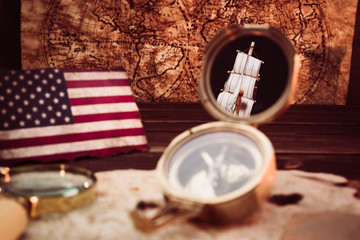 Old vintage maps and marine equipment like compass, magnifier or hourglass and ship. Columbus Day...