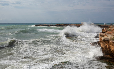 White ocean waves crashing to rocks
