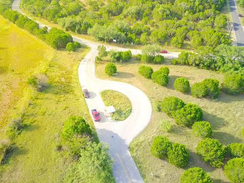 Aerial View Green Country Road In Texas Hill Country With Circle Ranch Entrance. Farmland Rolling Landscape Flyover