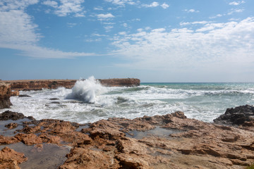 White ocean waves crashing to rocks