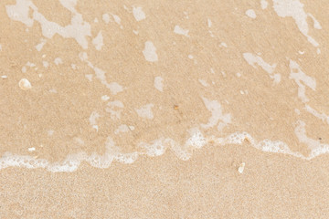 Sea wave on sand beach background.
