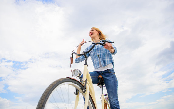 Girl rides bike sky background. Emotional woman enjoy biking holidays. Lady cyclist with cruiser bike. Girl spend leisure riding bicycle. Latest news for recreational and leisure cyclists