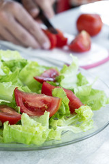 young man preparing a green salad