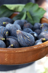 ripe figs in a rustic earthenware bowl
