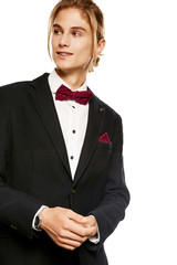A handsome young man in a blazer and button up shirt, accessorized with a burgundy red pinstripe...