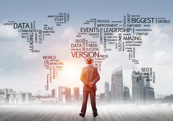 Motivation and inspiration concept with modern cityscape and businessman observing it