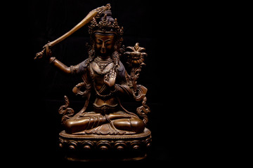 Decorative buddhistic sculpture on a black background