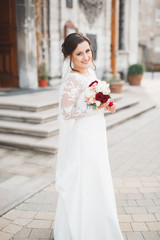Naklejka premium Portrait of stunning bride with long hair posing with great bouquet