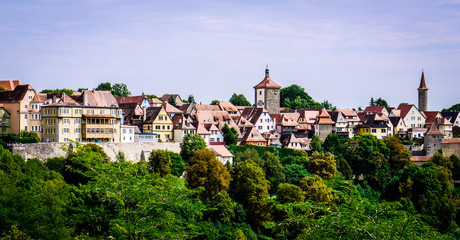 Fototapeta na wymiar Colorful buildings of Rothenburg Ob Der Tauber in Germany. Showing timber framed and stone buildings of the whole city as well as the wall and watchtowers.