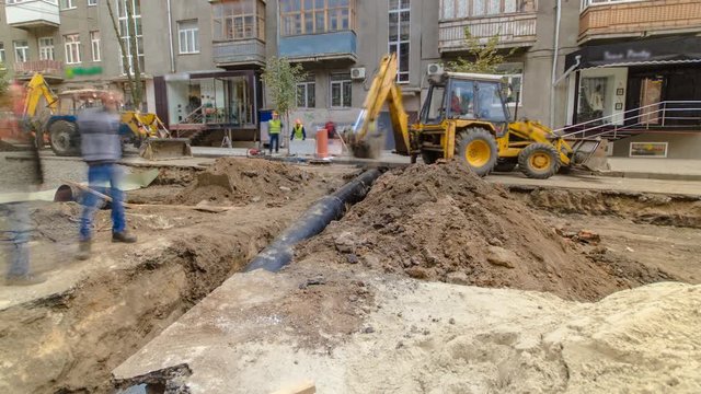 Excavator at working on pipeline construction site of replacing water supply pipe timelapse