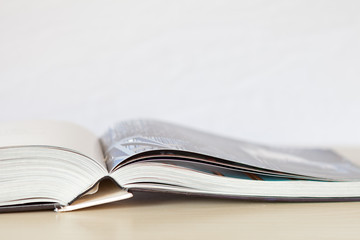 Book laying flat open on bright surface with white background