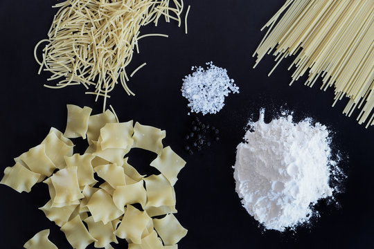 Three different types of pasta are laid out on black background