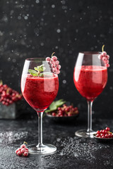 Fresh currant cocktail. Fresh summer cocktail with red currant and ice cubes. Glass of red currant mojito