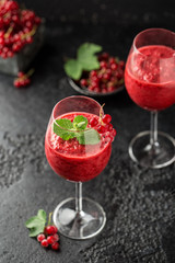 Fresh currant cocktail. Fresh summer cocktail with red currant and ice cubes. Glass of red currant mojito