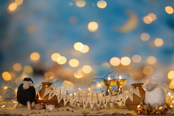 Happy Eid al-Adha! Happy Feast of Sacrifice! White and black lamb, tagine and night blue sky in the background.