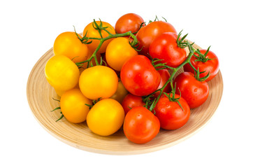 Ripe juicy tomatoes on large wooden plate