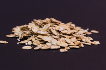 Close-up of oat flakes on black background