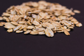 Close-up of oat flakes on black background