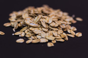 Close-up of oat flakes on black background