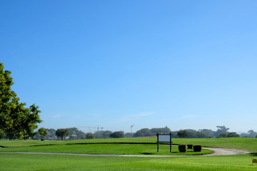 Fototapeta na wymiar Pristine Golf Course with Blank Sign on green