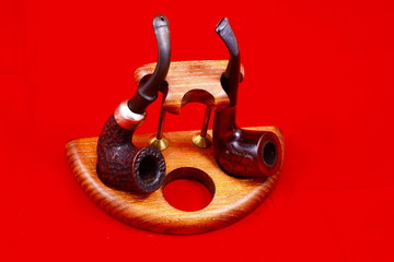 Smoking tubes, a violin and a mirror on a red background.