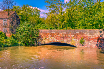 High flood water of the Great Stour river under a bridge in Canterbury, Kent, Uk on a sunny day...