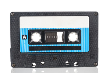 Old dusty audio tape cassette isolated on white background