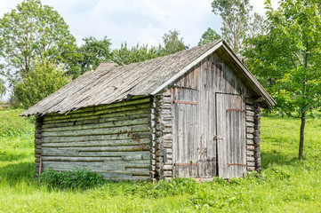 Old wooden barn in forest.
