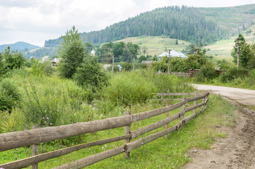Fototapeta na wymiar Old wooden fence in the mountain's village.