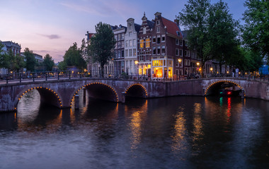 Bridge over Keizersgracht - Emperor's canal in Amsterdam, The Netherlands at twilight.