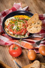 Homemade breakfast fried egg with tomato.