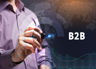 The concept of business, technology, the Internet and the network. A young entrepreneur working on a virtual screen of the future and sees the inscription: B2B