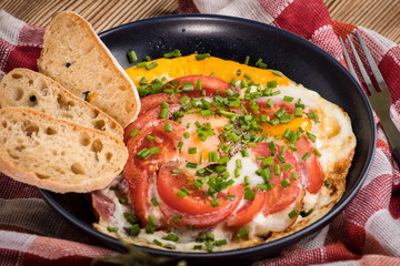 Homemade breakfast fried egg with tomato.